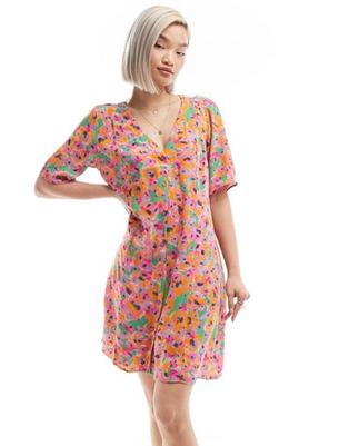 Προσφορά Monki button through mini dress in abstract floral print για 25€ σε Asos